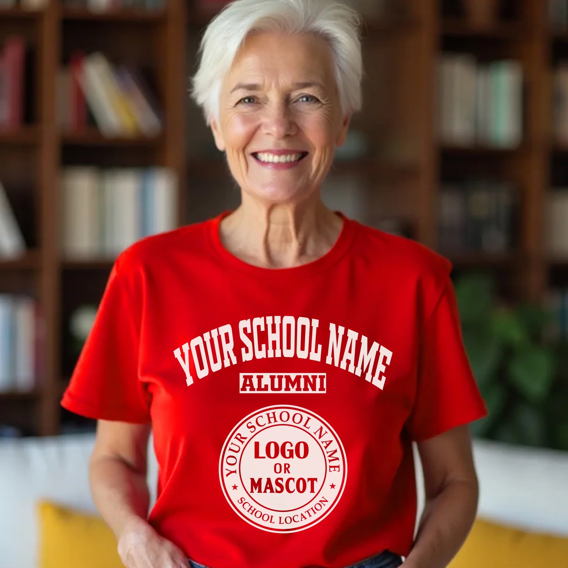 A cheerful female alumna wearing a red personalized shirt with her high school's classic logo.
