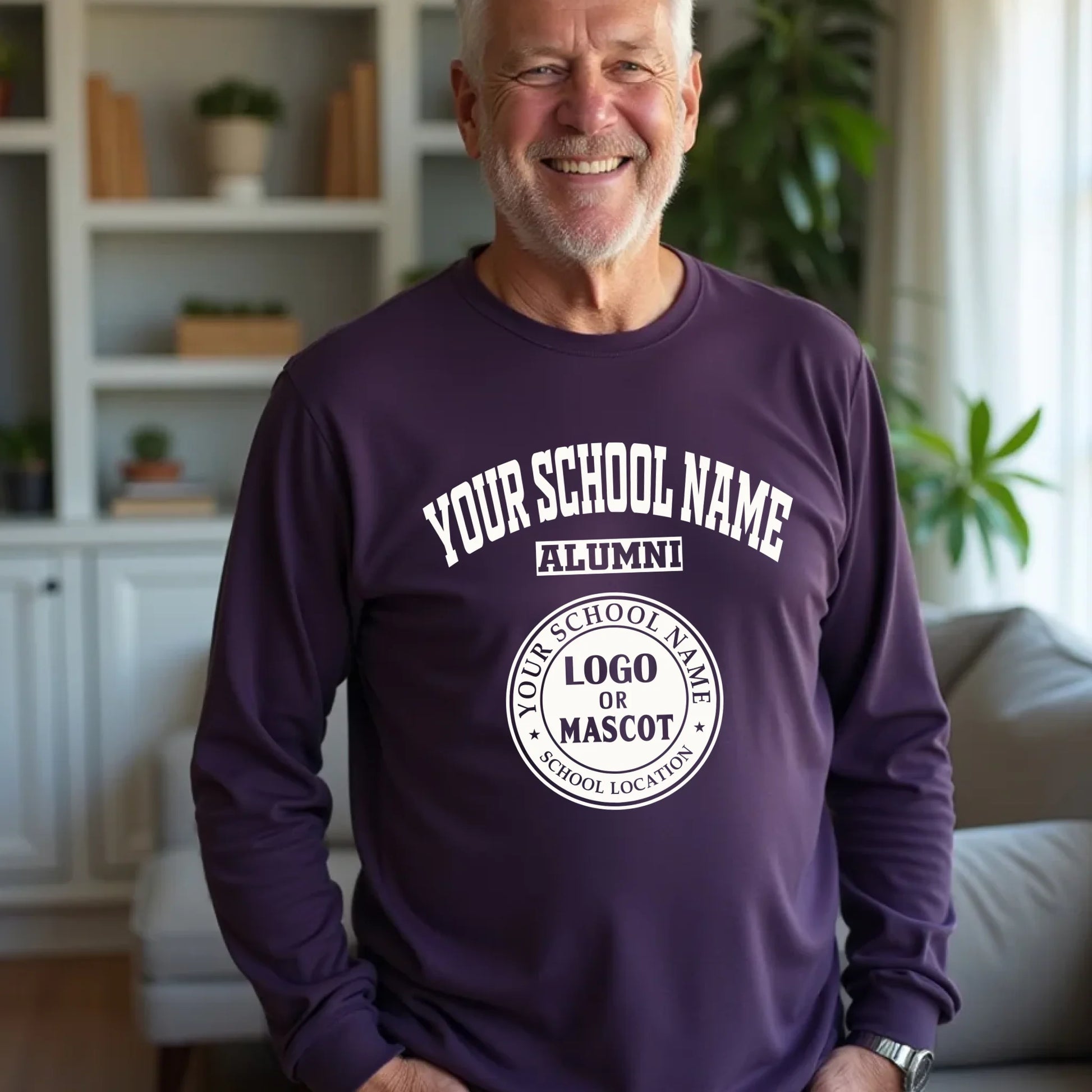 A smiling male alumnus wearing a purple personalized long sleeve tee with his classic college logo.
