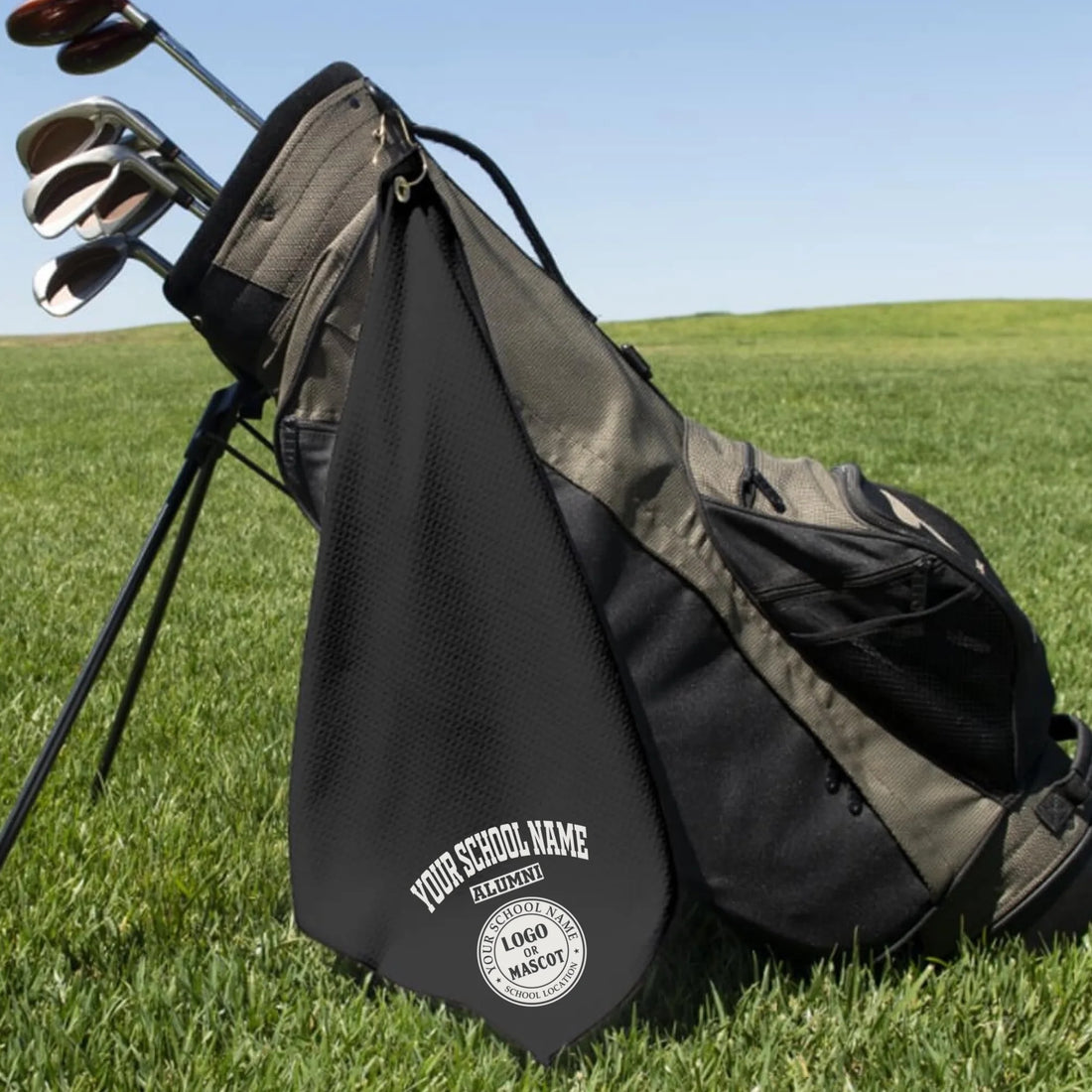 A classic black custom alumni golf towel, a perfect and practical gift for class reunions or alumni golf tournaments.