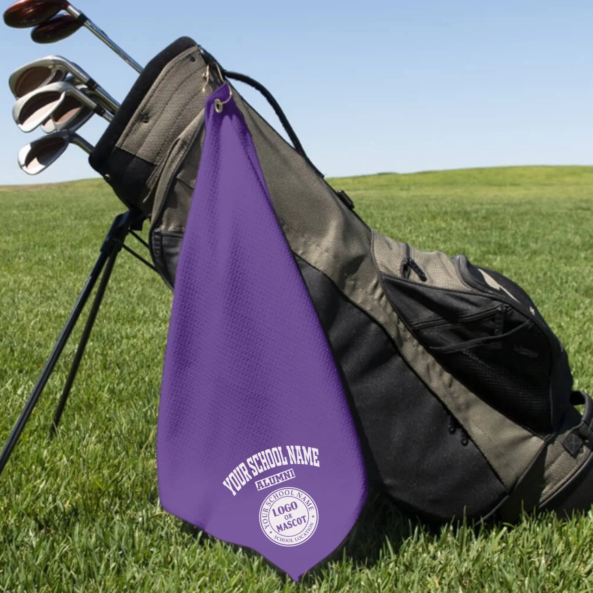 A classic black custom alumni golf towel, a perfect and practical gift for class reunions or alumni golf tournaments.
