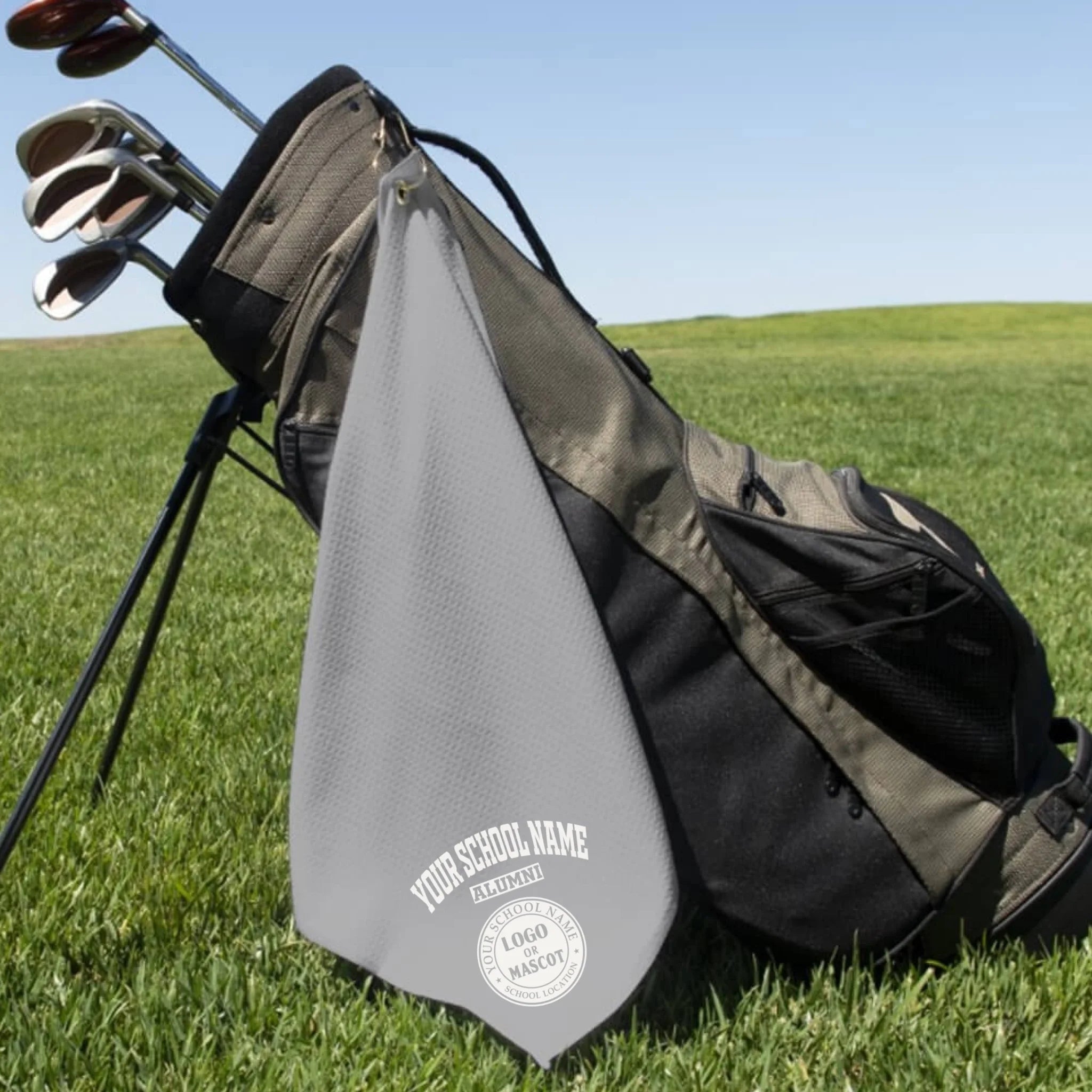 A classic black custom alumni golf towel, a perfect and practical gift for class reunions or alumni golf tournaments.