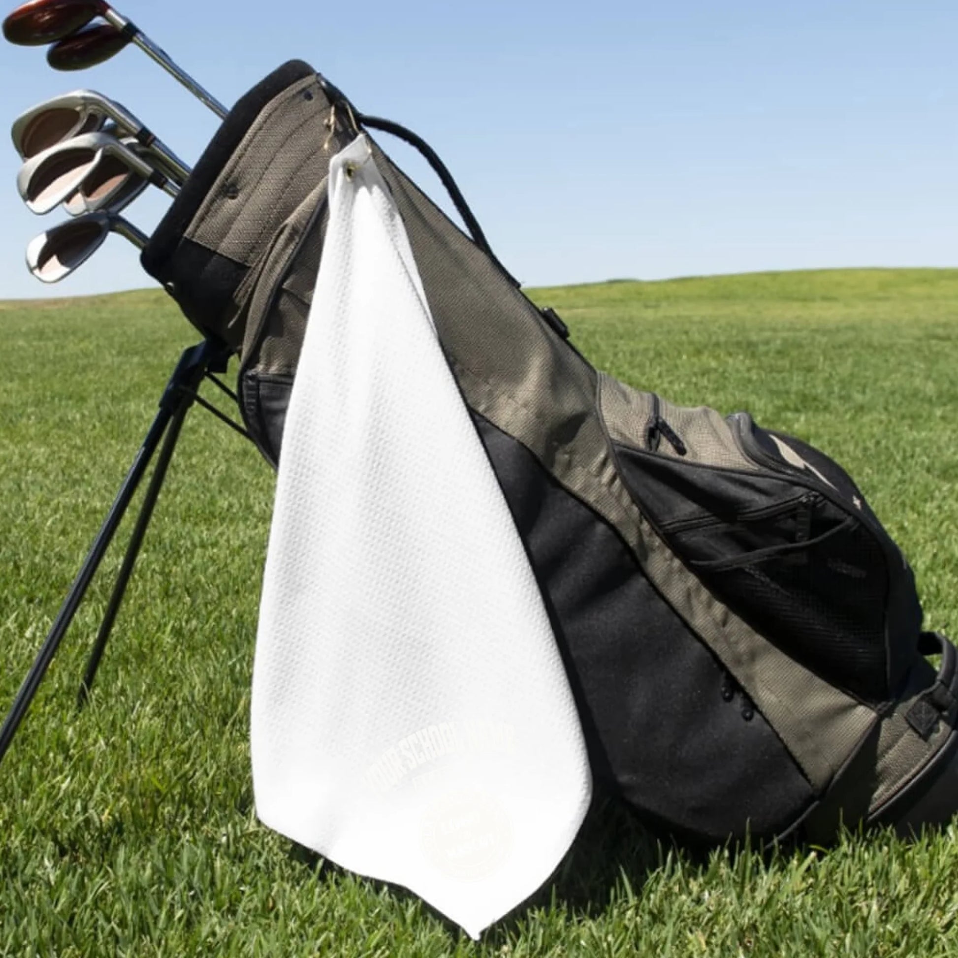 A classic black custom alumni golf towel, a perfect and practical gift for class reunions or alumni golf tournaments.