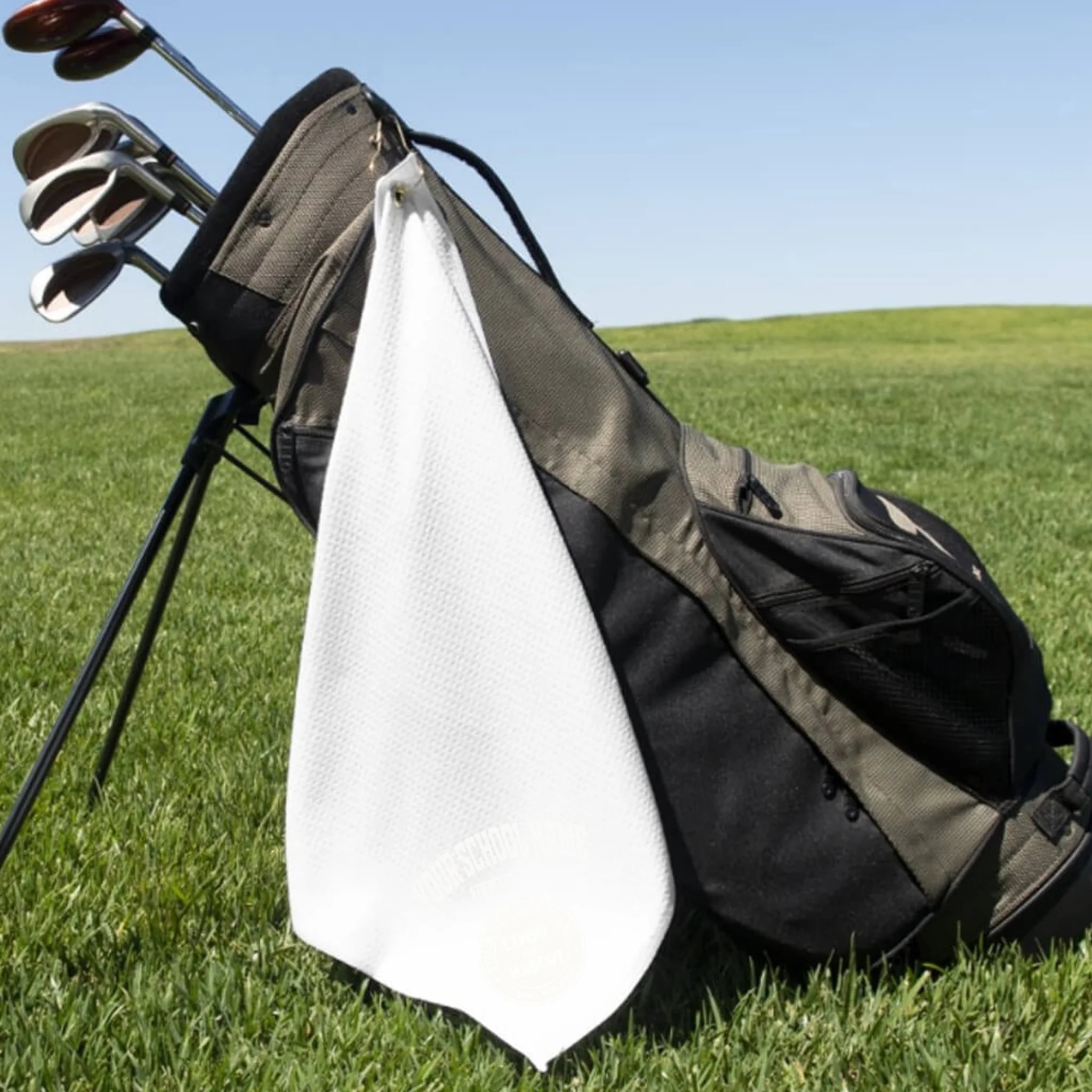 A classic black custom alumni golf towel, a perfect and practical gift for class reunions or alumni golf tournaments.